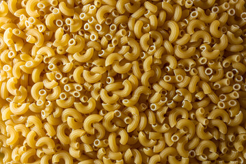 Uncooked Chifferi Rigati Pasta: A Culinary Canvas of Chifferi Rigati, Creating a Lively and Textured Background for Gourmet Cooking. Dry Pasta. Raw Macaroni - Top View, Flat Lay