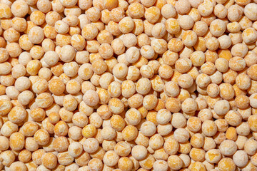 Uncooked Yellow Polished Peas Background. A Culinary Canvas of Dry Yellow Peas, Creating a Lively and Textured Background for Gourmet Cooking. Scattered Raw Polished Peas. Healthy Eating Ingredients