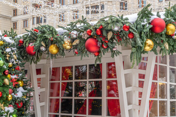 Christmas decorations on a snow-covered Christmas tree. Background of Christmas tree toys. Festive...