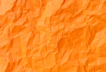 Fototapeta premium Top view and full frame of wrinkled or crumpled orange paper used as crumpled orange paper background texture.