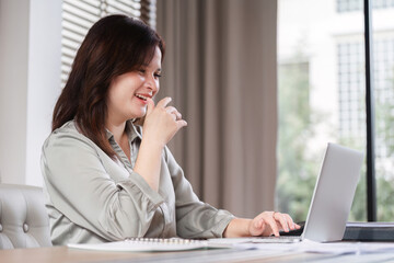 Focused Businesswoman Analyzing Documents and Strategizing Work Plans in a Modern Office Setting