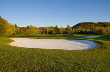 Fall Season Golf Sand Trap with Scenic Colorful Mountains in Background