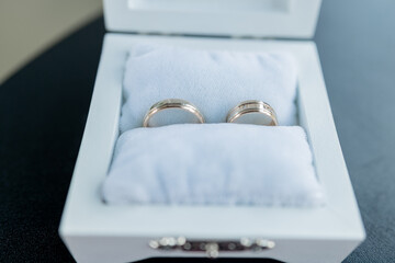 gold wedding rings in a ceremony box