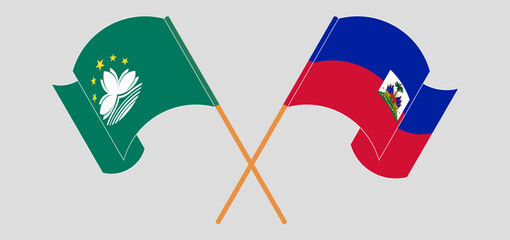 Crossed and waving flags of Macau and Republic of Haiti. Vector illustration