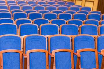 Conference hall with rows of blue seats