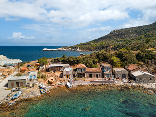 Old dock with boats in Ormos Agios Isidoros on Greek Samos island, summer day, drone view.