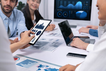 Analyst team uses BI Fintech display tablet to analyze financial data . Business people analyze BI software technology dashboard power for insights power into business marketing planning. Prudent