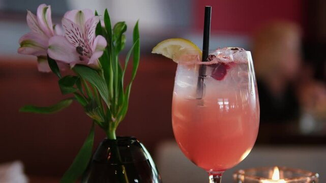 pink lemon cocktail Raspberry lemonade or cocktail with slices of lemon and fresh mint being stirred with a bar spoon