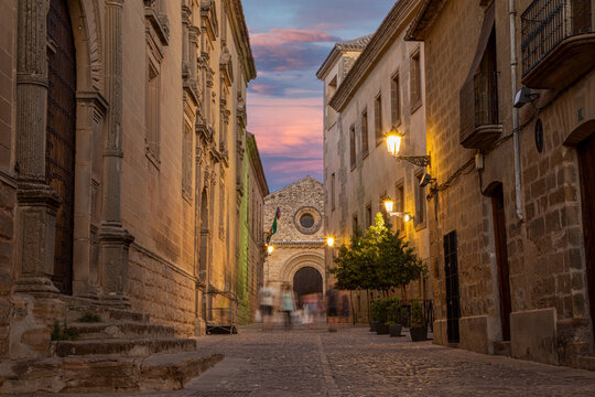 Street of the historic center of Baeza with blurred people walking in Baeza, Ja&eacute;n, Andalusia, Spain at dusk, UNESCO heritage