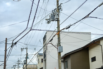 The view of utility pole, electric wires, electricity pylon at street in Kyoto, Japan. 