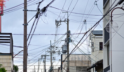 Fototapeta na wymiar The view of utility pole, electric wires, electricity pylon at street in Kyoto, Japan. 