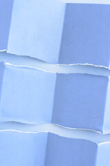 blue scrapbooking paper background with folded and torn elements