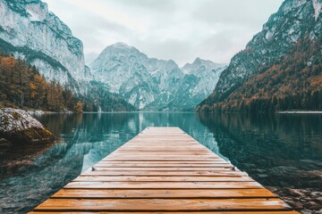 Obraz premium Wooden Dock Extending into a Tranquil Mountain Lake