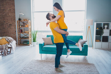 Full size photo of two young partners hold arms good mood free time modern interior apartment indoors