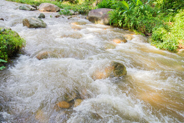 water flowing  over rocks into the river