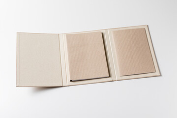 Coupled cardboard folder, open and with two notepads glued inside with corrugated cardboard covers. Elegant portable office tool made of recycled material
