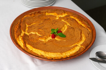Delight in the traditional Portuguese sericaia, a creamy custard dessert, topped with a sprinkle of...