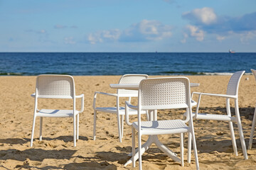 Empty seats of an outdoor cafe on an empty beach in the city of Sopot, Poland