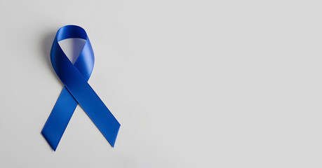 Blue awareness ribbon isolated on blue background. World diabetes day, 14 november, prostate cancer awareness banner. Blue November, International Men's Day concept with copy space