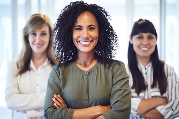 Obraz premium Women, portrait and staff with arms crossed in office, solidarity and diversity in company. Business people, team of experts and confident in consulting on opportunity, leadership and mission support