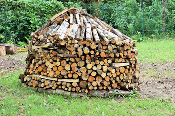 Rural life. A large stack of firewood, neatly stacked and prepared for the heating season.