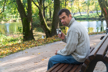 man walks through the forest and sits on a stump, he measures his blood sugar, diabetes, diabetes disease