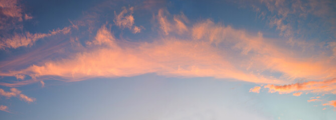 sunset sky panorama with blue background and lighted cirrus cloud