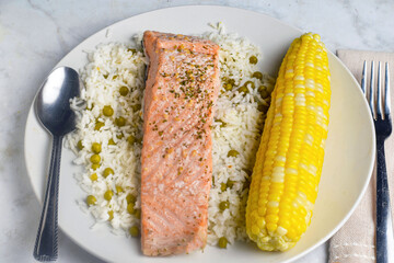 seasoned  baked salmon  with rice and corn