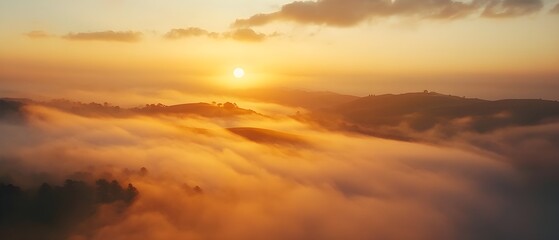Sunrise over Foggy Hills and Valleys
