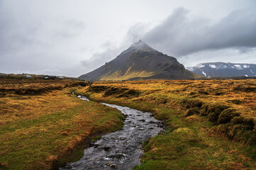 views of the cliffs surrounding the village of Arnarstapi during a rainy day on the Snaefellnes...