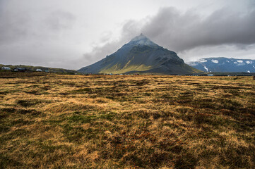 views of the cliffs surrounding the village of Arnarstapi during a rainy day on the Snaefellnes...