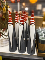 Shelf with New Year's goods in the store. New Year's gnomes, Christmas decorations, figurines of Christmas trees. New Year and Christmas concept