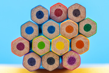 Hexagonal Pattern of Colored Pencils on Blue Background