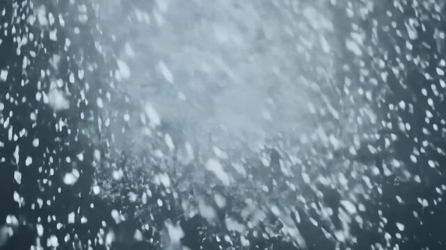 Swirling snowflakes in a blizzard create a mesmerizing top-view, flat lay scene with intense movement and wind effects, covering the frame with a chaotic storm of ice and snow.