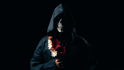 black death holds flowers in his hand