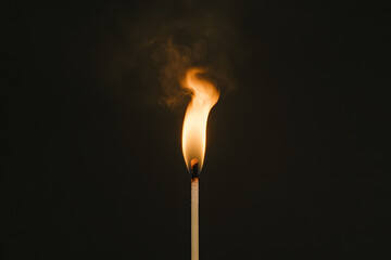 burning match on black background