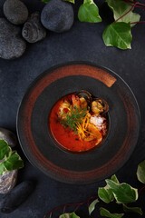Thai Tom Yam soup with seafood. Large mussels. Asian cuisine. An exquisite serving of Tom Yam soup. Top view.