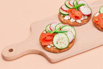 Crispy Cracker Sandwiches with Fresh Salmon, Cucumber, Radish, Cottage Cheese and Green Onions. Easy Breakfast. Quick and Healthy Sandwiches. Crispbread with Tasty Filling. Healthy Dietary Snack