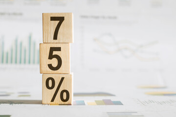 75 Percent a word written on wooden cubes on a white background.