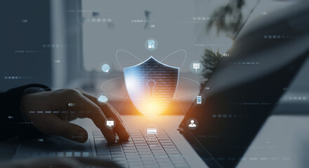 Person using laptop with digital padlock shield.Cyber security protection concept.Data protection...