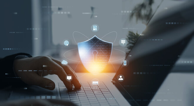 Person using laptop with digital padlock shield.Cyber security protection concept.Data protection concept.Protecting herself from cyber attacks and personal data.Cyber security network.