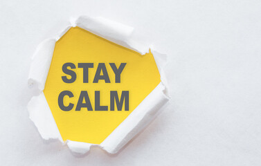 Stay Calm Message Written on Yellow Paper Under Ripped White Paper