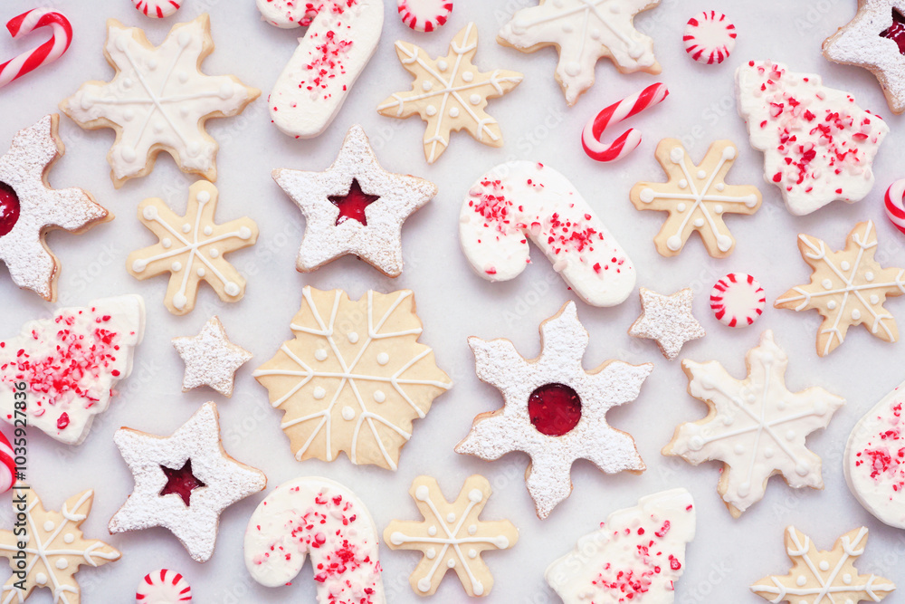 Poster christmas baking background with a selection of red and white theme cookies and candies. overhead vi