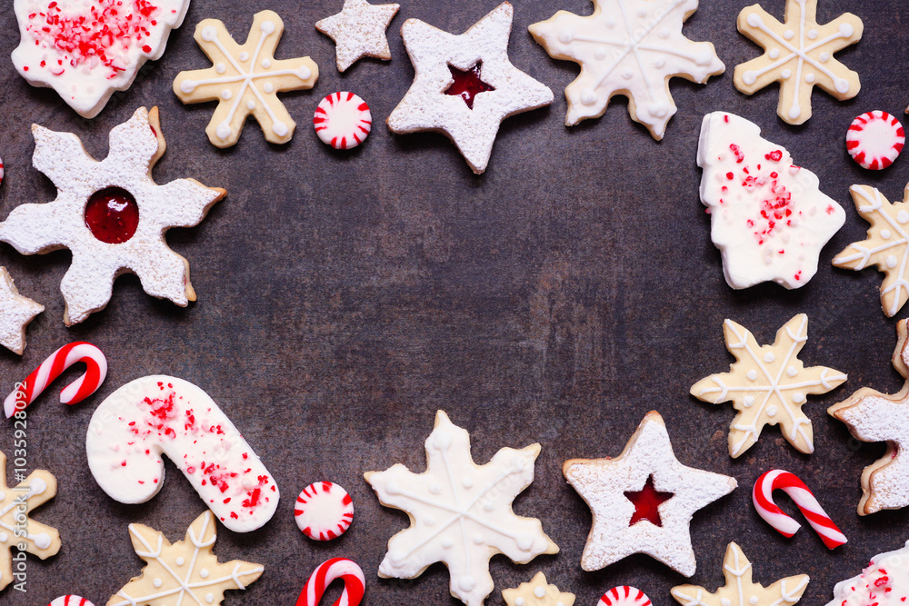 Poster christmas baking frame with a variety of red and white theme cookies and candies. top down view on a