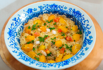 Traditional Brazilian dish rice, chicken and pequi (caryocar brasileinse) known as galinhada goiana