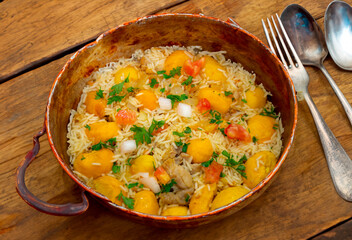 Traditional Brazilian dish rice, chicken and pequi (caryocar brasileinse) known as galinhada goiana
