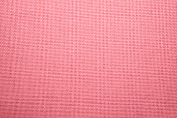 Woven fabric texture. Pink material texture. Close-up photograph jpg.