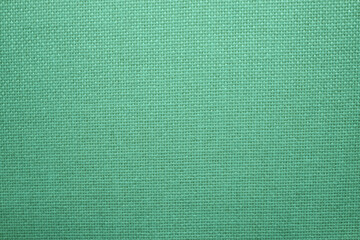 Woven fabric texture. Green material texture. Close-up photograph jpg.
