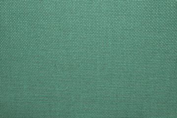 Woven fabric texture. Green material texture. Close-up photograph jpg.