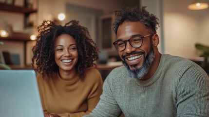 A cheerful couple, one wearing glasses, is pictured using a laptop in a stylish home office, highlighting themes of collaboration, technology, and modern living.